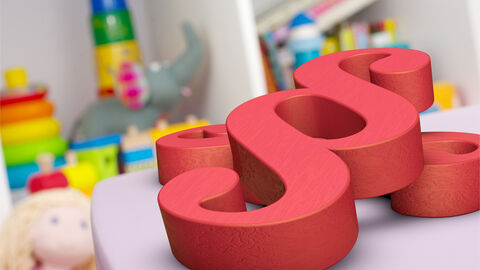 Paragraph, Gesetz Kinderspielsachen liegen im Hintergrund, ein Paragraphenzeichen liegt im Vordergrund