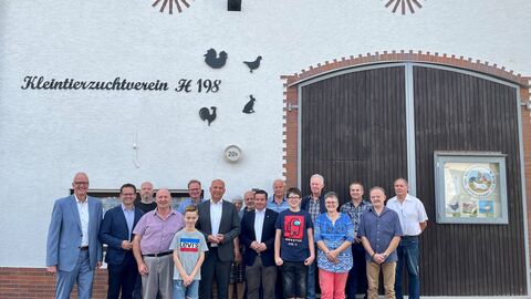 Justizminister Roman Poseck mit dem Vorsitzenden des Kleintierzuchtverein H 198 e.V. Obertiefenbach Alfred Zöller, Bürgermeister Michael Franz, den Mitgliedern des Hessischen Landtags Andreas Hofmeister und Tobias Eckert sowie weiteren Mitgliedern des Vereins 